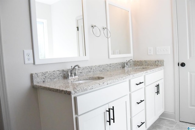 bathroom with tile patterned flooring, double vanity, and a sink