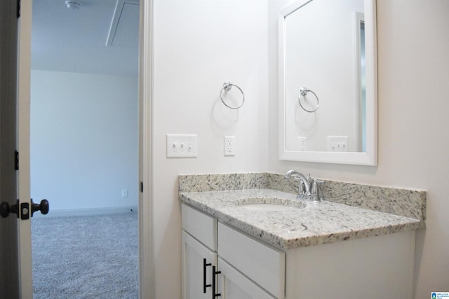 bathroom with vanity and baseboards