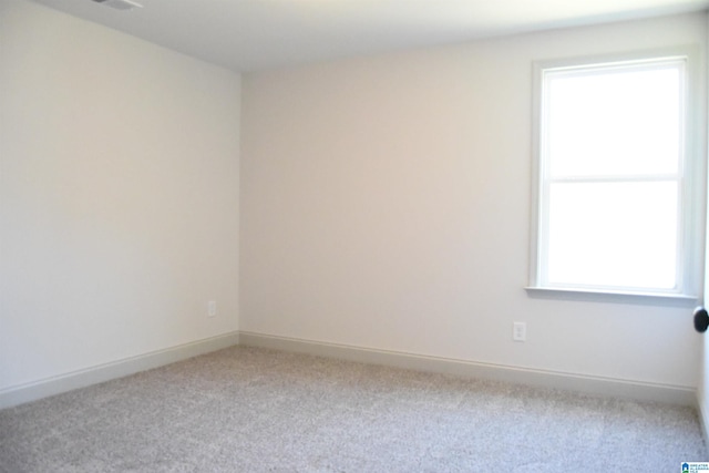 empty room with carpet and baseboards