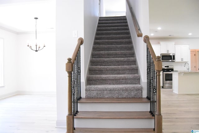 staircase featuring recessed lighting, a chandelier, baseboards, and wood finished floors