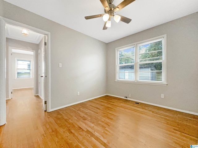2400 2nd Ave N, Irondale, AL 35210 - spare room with baseboards, light wood-style flooring, ceiling fan, and a healthy amount of sunlight
