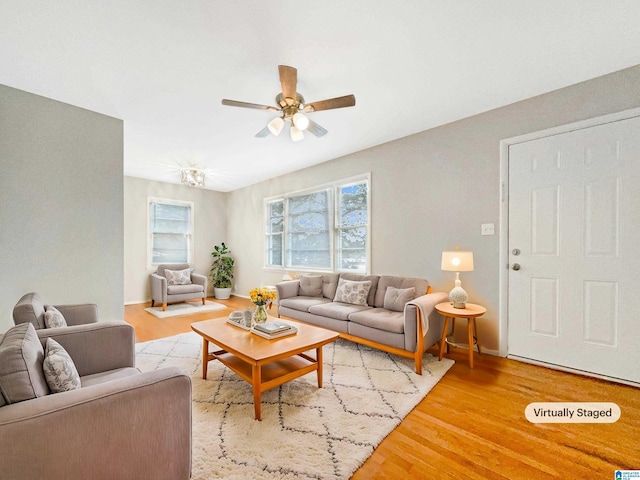 living room with hardwood / wood-style flooring and ceiling fan