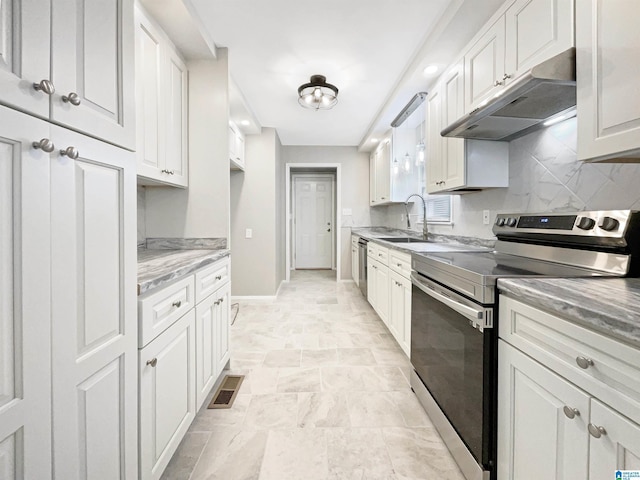 2400 2nd Ave N, Irondale, AL 35210 - kitchen featuring visible vents, under cabinet range hood, a sink, backsplash, and stainless steel appliances