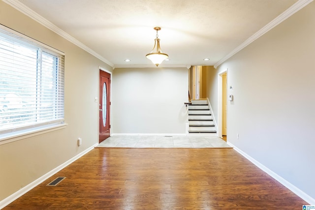 unfurnished room featuring crown molding and light wood-type flooring