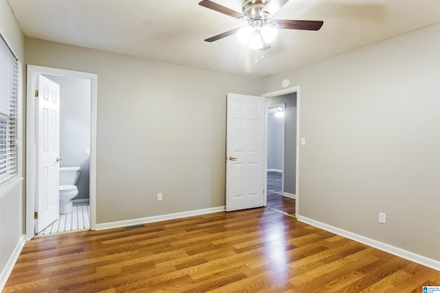 5268 Goldmar Dr, Irondale, AL 35210 - unfurnished bedroom featuring light wood-type flooring, ensuite bath, baseboards, and a ceiling fan