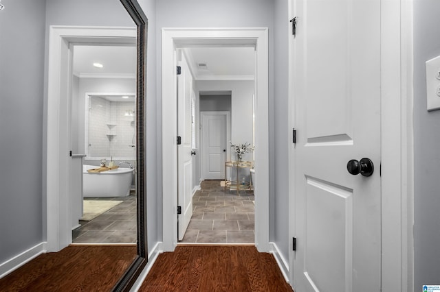 corridor featuring crown molding and dark hardwood / wood-style flooring