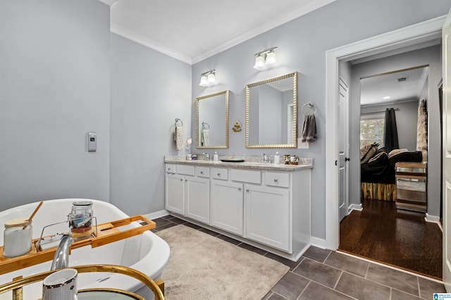 bathroom featuring vanity, ornamental molding, hardwood / wood-style flooring, and a bath