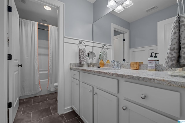 full bathroom featuring toilet, shower / tub combo with curtain, vanity, and tile patterned floors