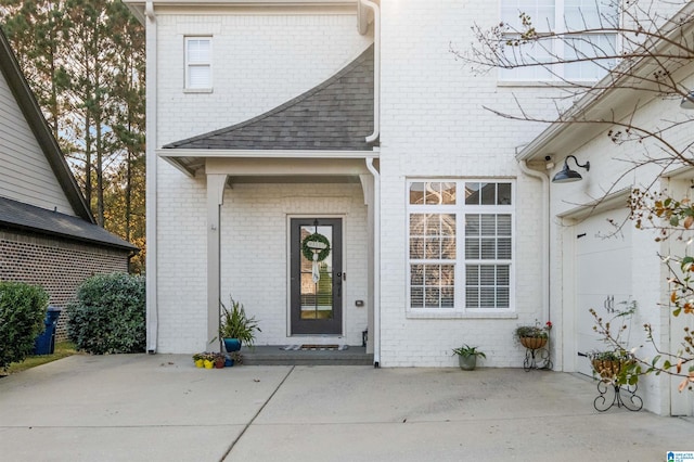 view of exterior entry with a patio area