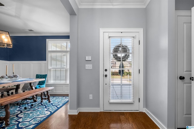 doorway to outside featuring ornamental molding and dark hardwood / wood-style flooring