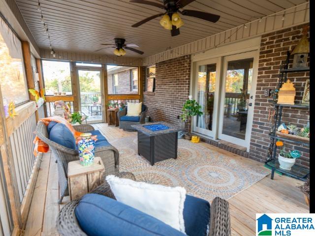 sunroom / solarium with ceiling fan and wooden ceiling