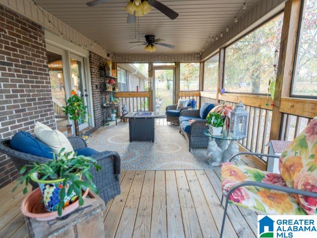 sunroom with wood ceiling and ceiling fan