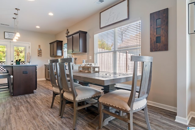 dining space featuring french doors and dark hardwood / wood-style floors