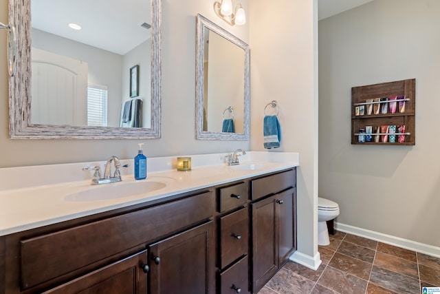 bathroom featuring toilet and vanity