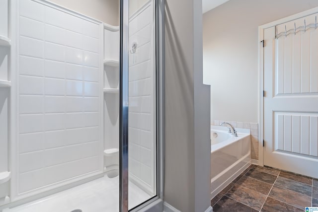 bathroom featuring shower with separate bathtub