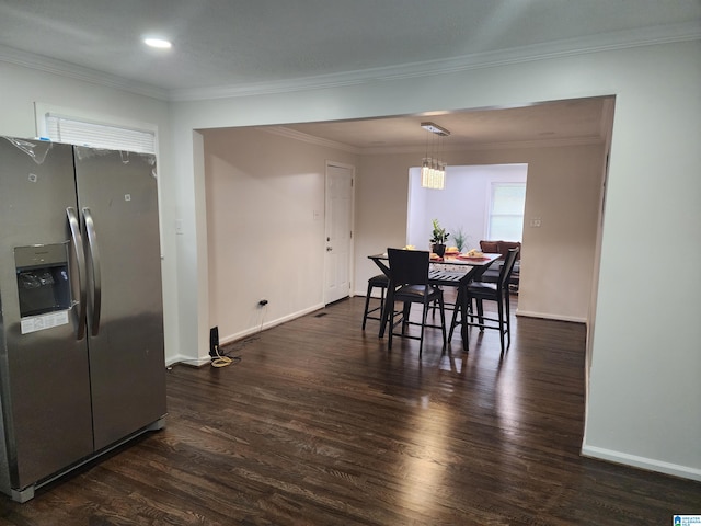 dining area featuring dark wood-type flooring and ornamental molding