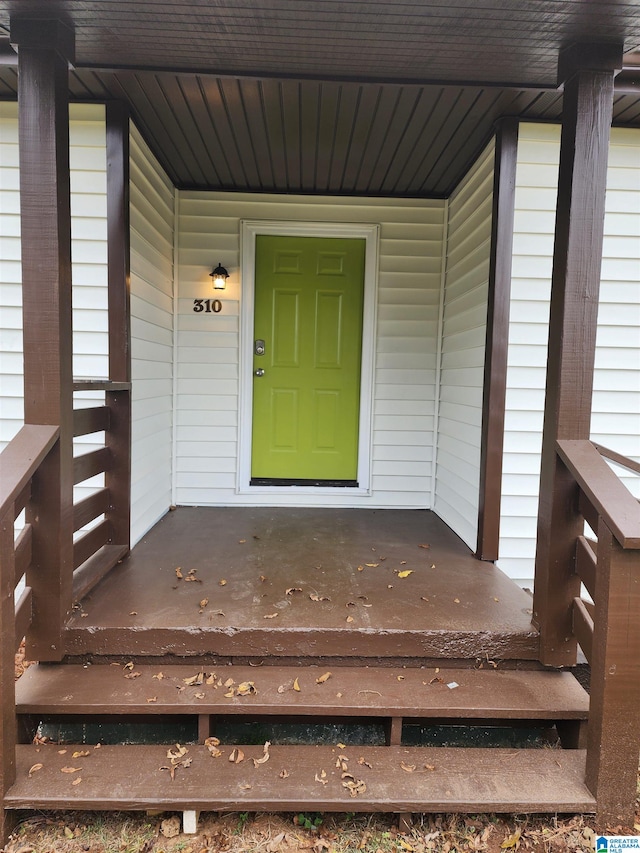 view of exterior entry featuring a porch