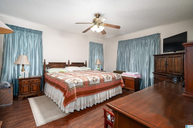 bedroom featuring ceiling fan, a textured ceiling, and dark hardwood / wood-style flooring