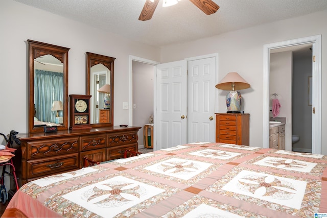 bedroom with a closet, ensuite bathroom, a textured ceiling, and ceiling fan