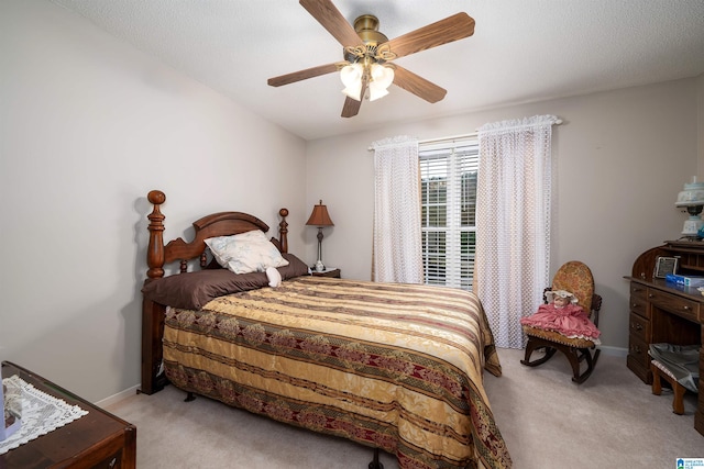 carpeted bedroom featuring a textured ceiling and ceiling fan