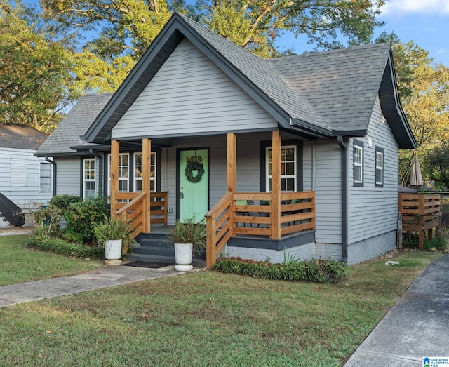 bungalow with a front yard and a porch