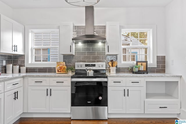 kitchen with wall chimney exhaust hood, light stone countertops, stainless steel electric range, white cabinetry, and dark hardwood / wood-style flooring