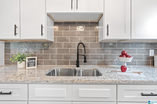 kitchen featuring tasteful backsplash and white cabinets