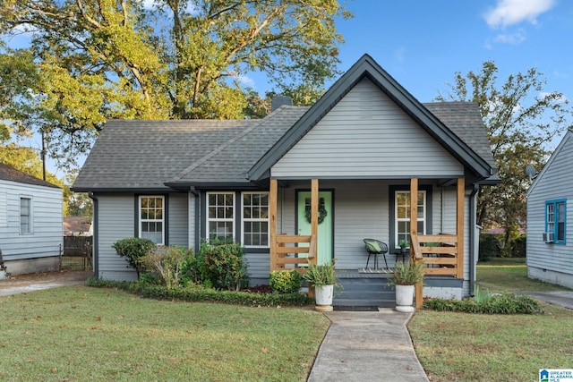 bungalow featuring a front lawn and a porch