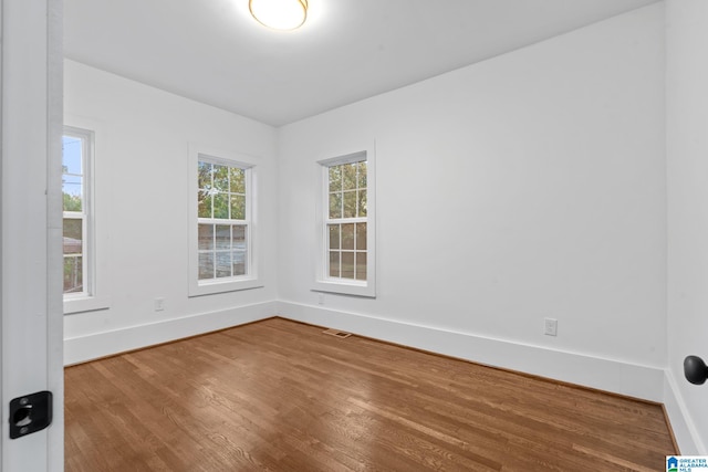 spare room featuring hardwood / wood-style flooring