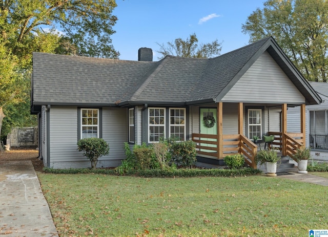 bungalow with a front yard and a porch