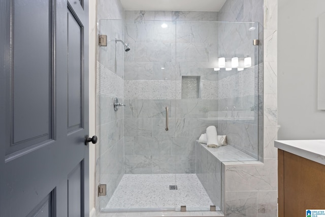 bathroom featuring vanity and a shower with shower door