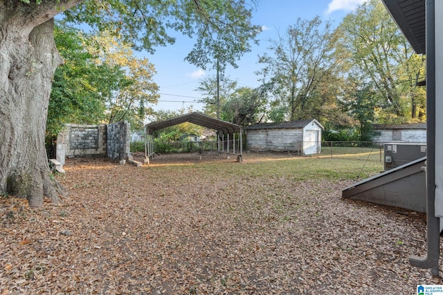 view of yard featuring a storage shed and a carport