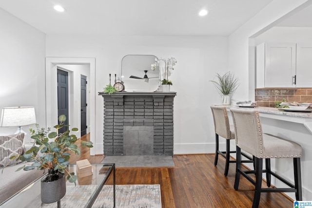 dining space with dark hardwood / wood-style floors and a fireplace