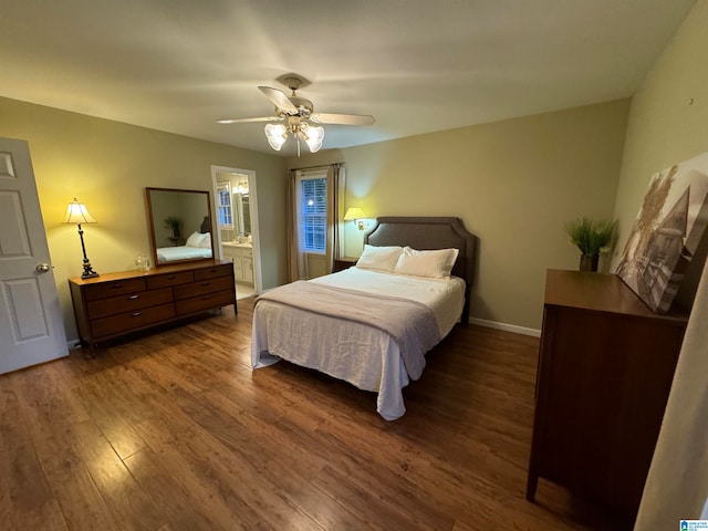 bedroom featuring connected bathroom, ceiling fan, and dark hardwood / wood-style flooring