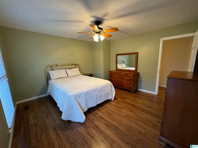 bedroom featuring dark hardwood / wood-style flooring and ceiling fan