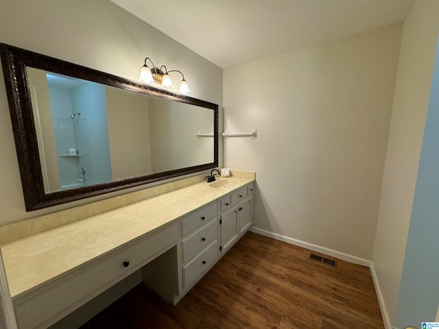 bathroom with vanity and hardwood / wood-style floors