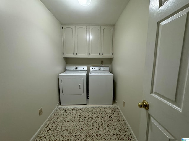 clothes washing area featuring cabinets and washing machine and clothes dryer