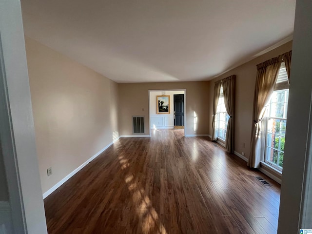 unfurnished living room with dark wood-type flooring