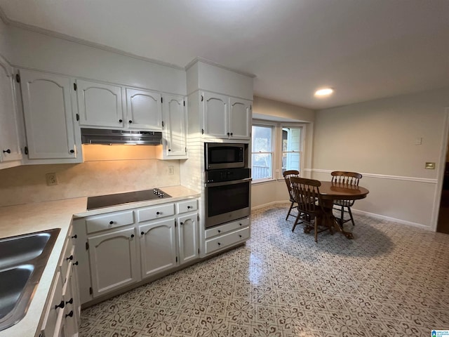 kitchen featuring white cabinets, tasteful backsplash, stainless steel appliances, and sink