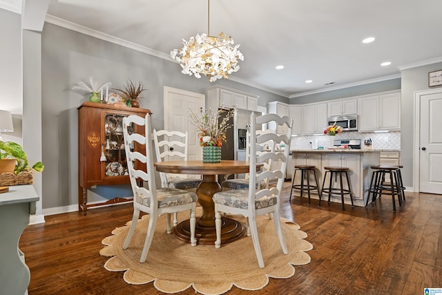 dining area featuring ornamental molding, a notable chandelier, and dark hardwood / wood-style floors