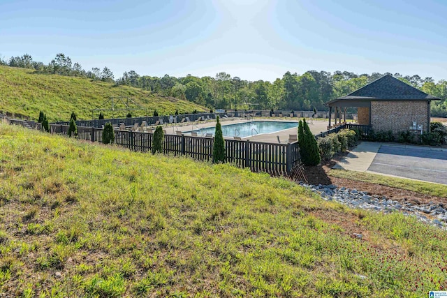 view of yard featuring a community pool and a patio area