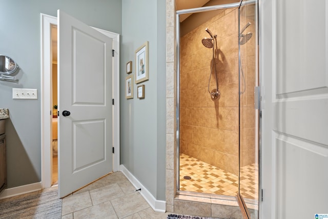 bathroom featuring vanity, walk in shower, and tile patterned flooring