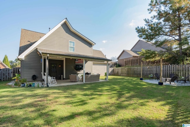 rear view of property with a yard and a patio area