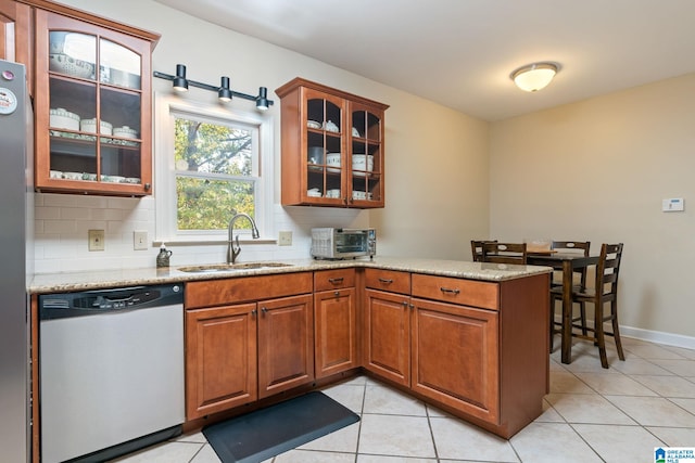 206 Morningside Cir Unit 206, Mountain Brook, AL 35213 - kitchen featuring a sink, stainless steel dishwasher, backsplash, and a peninsula