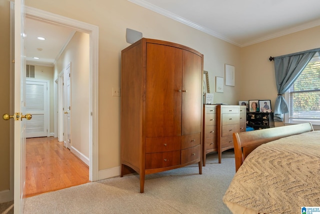 bedroom with ornamental molding and light hardwood / wood-style flooring