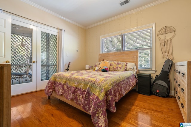 bedroom with ornamental molding, french doors, wood-type flooring, and access to exterior