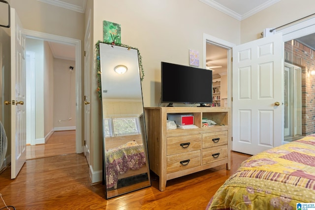 bedroom featuring hardwood / wood-style flooring and ornamental molding