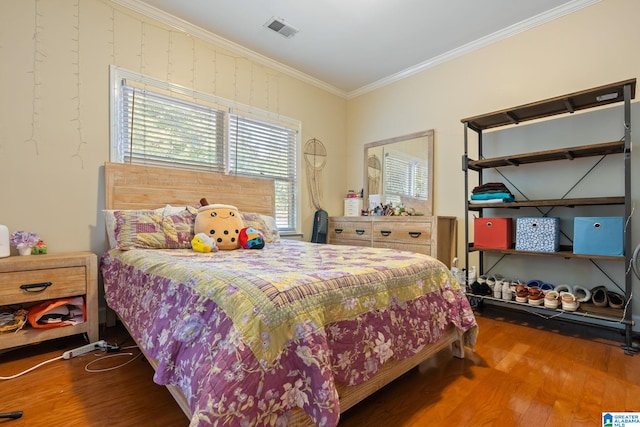 bedroom featuring crown molding and hardwood / wood-style flooring