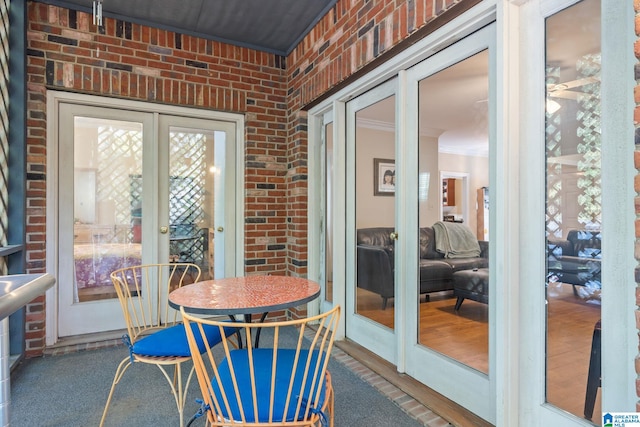 sunroom featuring french doors and a healthy amount of sunlight