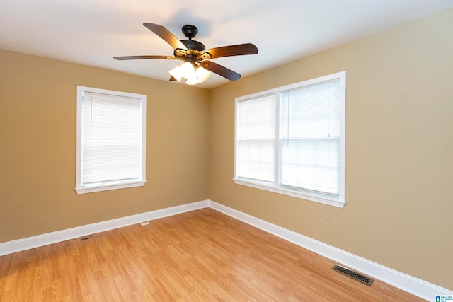 empty room with light hardwood / wood-style floors and ceiling fan